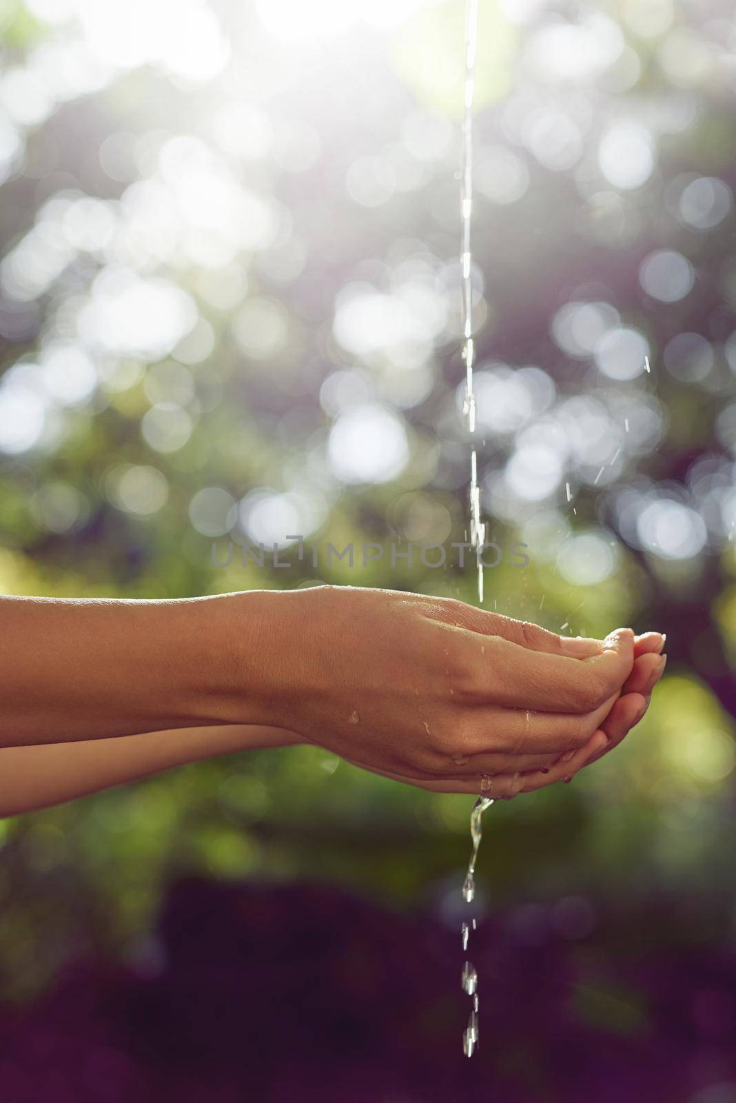 The source of all life. a woman washing her hands outdoors