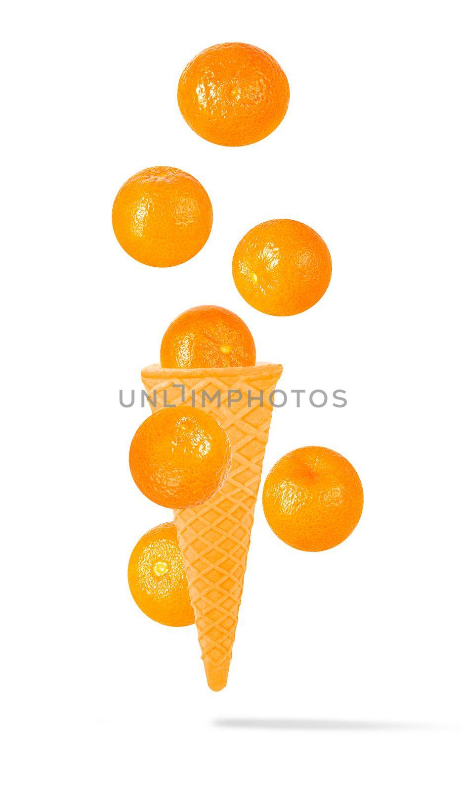 Isolated clementine on the air in ice cream waffle cone by Ciorba