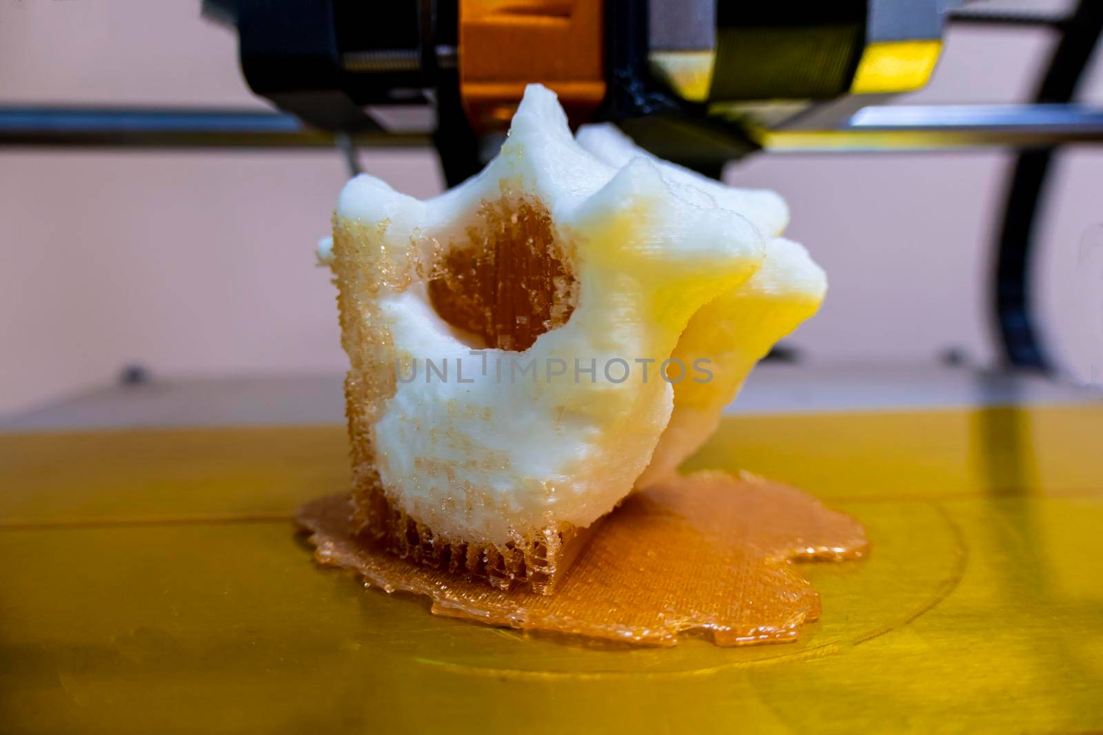printing vertebrae on a 3d printer. artificial body parts printed on a 3d printer. New era of medicine. printing on a 3d printer. orange trident is printed with plastic on a 3d printer