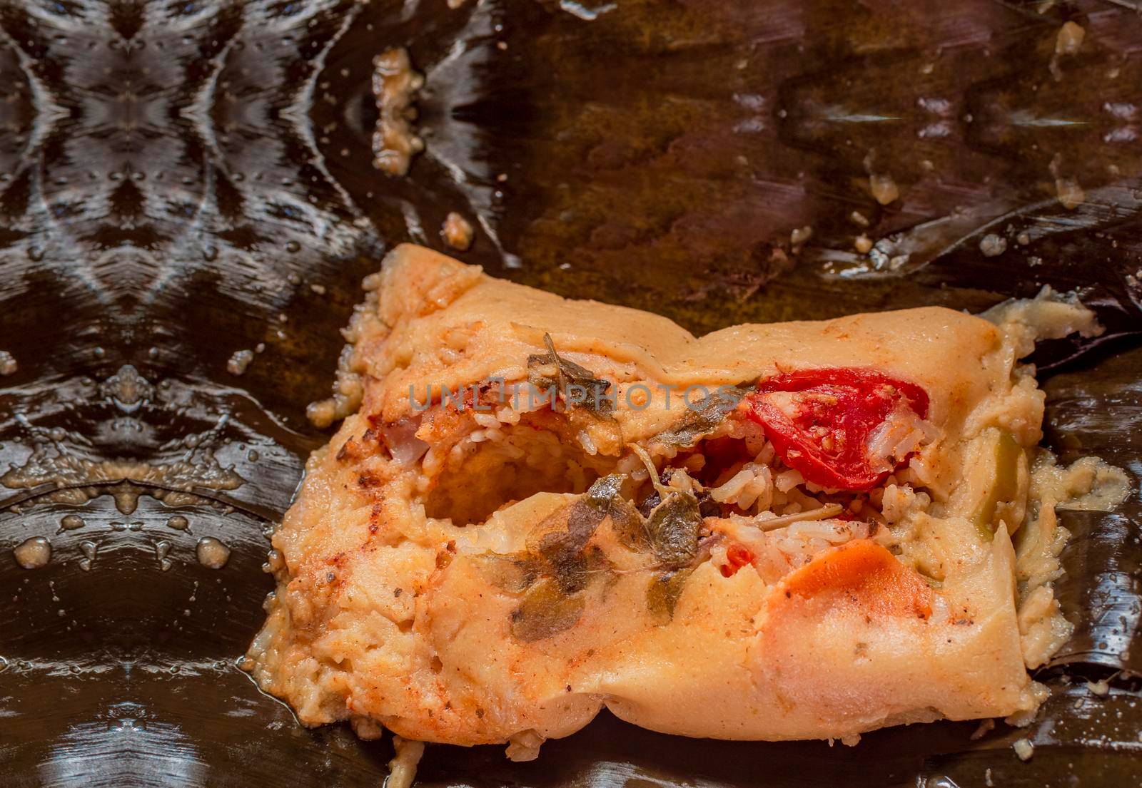 Homemade Nacatamal served in a banana leaf. Top view of traditional Nacatamal served on banana leaf, Close-up of Nicaraguan Nacatamal ready to eat, A freshly served traditional Nacatamal by isaiphoto