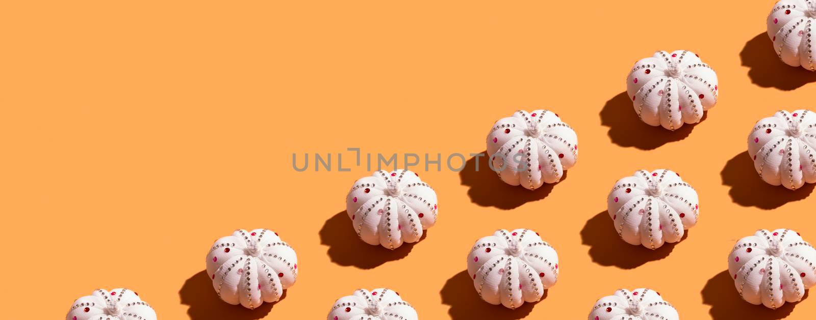 Banner from pattern with white decorative textile pumpkin with shiny stones. Autumn minimal harvest concept by ssvimaliss