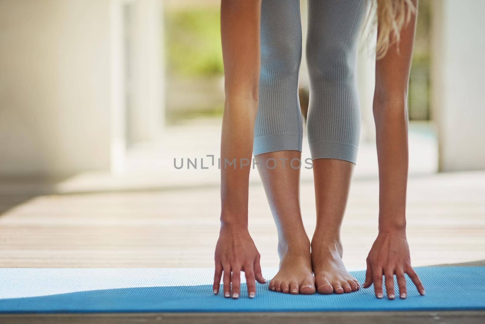 Getting ready for a workout. an unrecognizable woman stretching before her workout