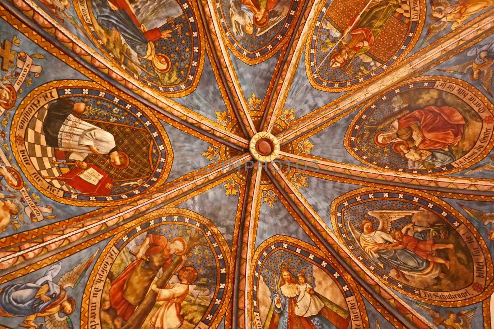 Rheine, NRW, Germany - August 24 2022 Art in the St. Dionysius church. The star-vaulted ceiling of the old sacristy, showing the patron saints of different groups within the community.