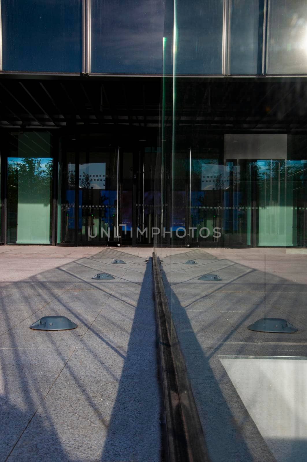 symmetric glass light reflection in office entrance. Madrid