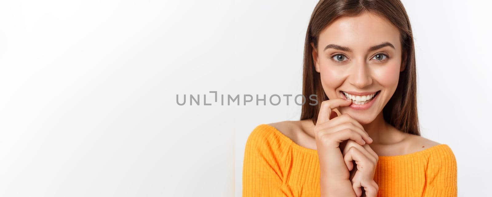 Close-up portrait of yong woman casual portrait in positive view, big smile, beautiful model posing in studio over white background