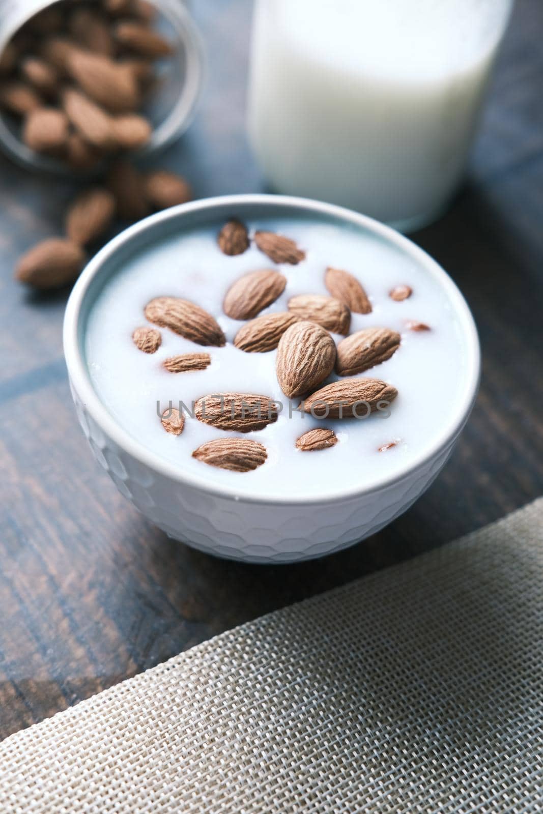 slow motion of pouring almond nuts in a milk ,