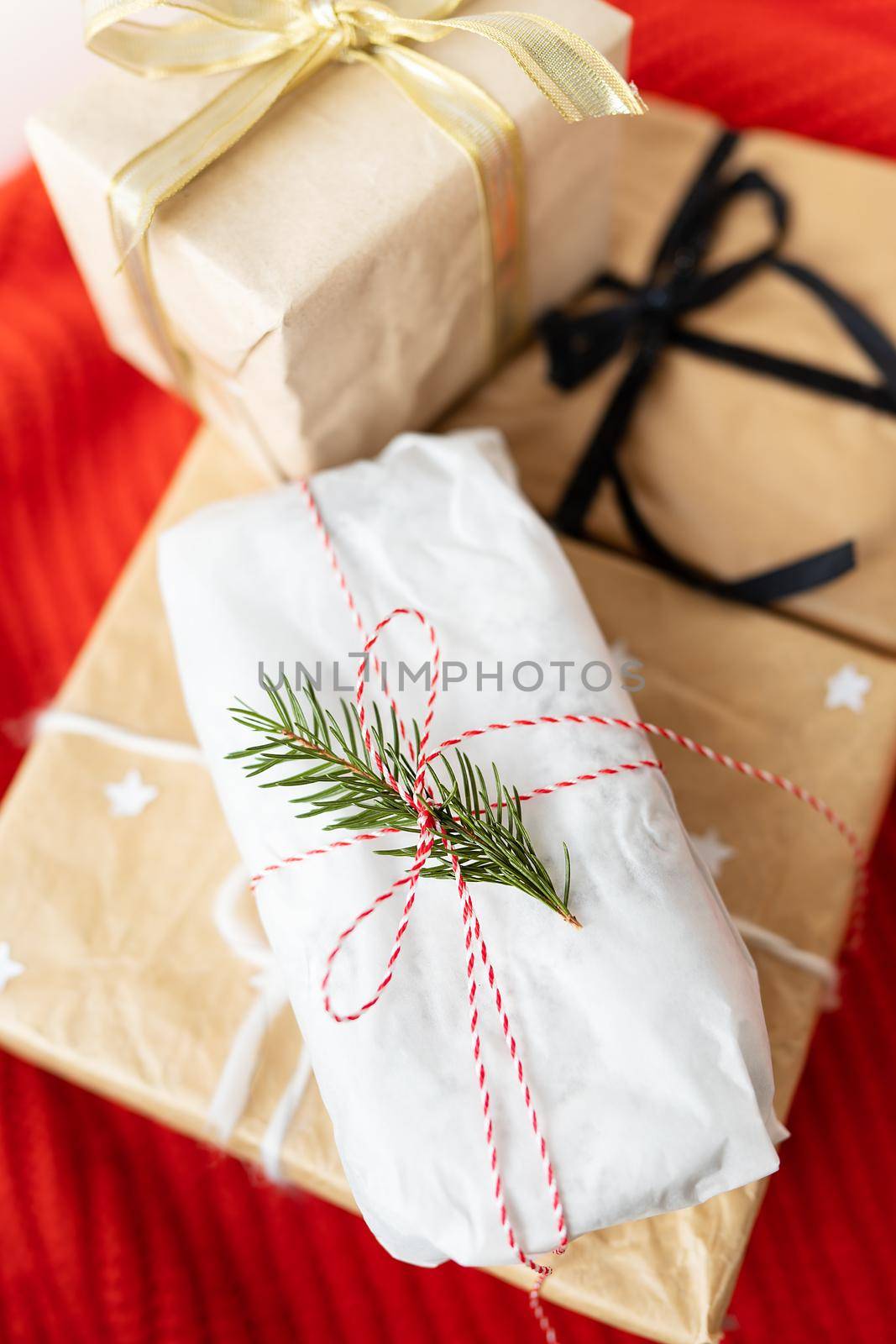 Gift boxes or gift wrapped in kraft paper and beautiful ribbons. The concept of the holiday, Christmas, New Year 2023-2024. by sfinks