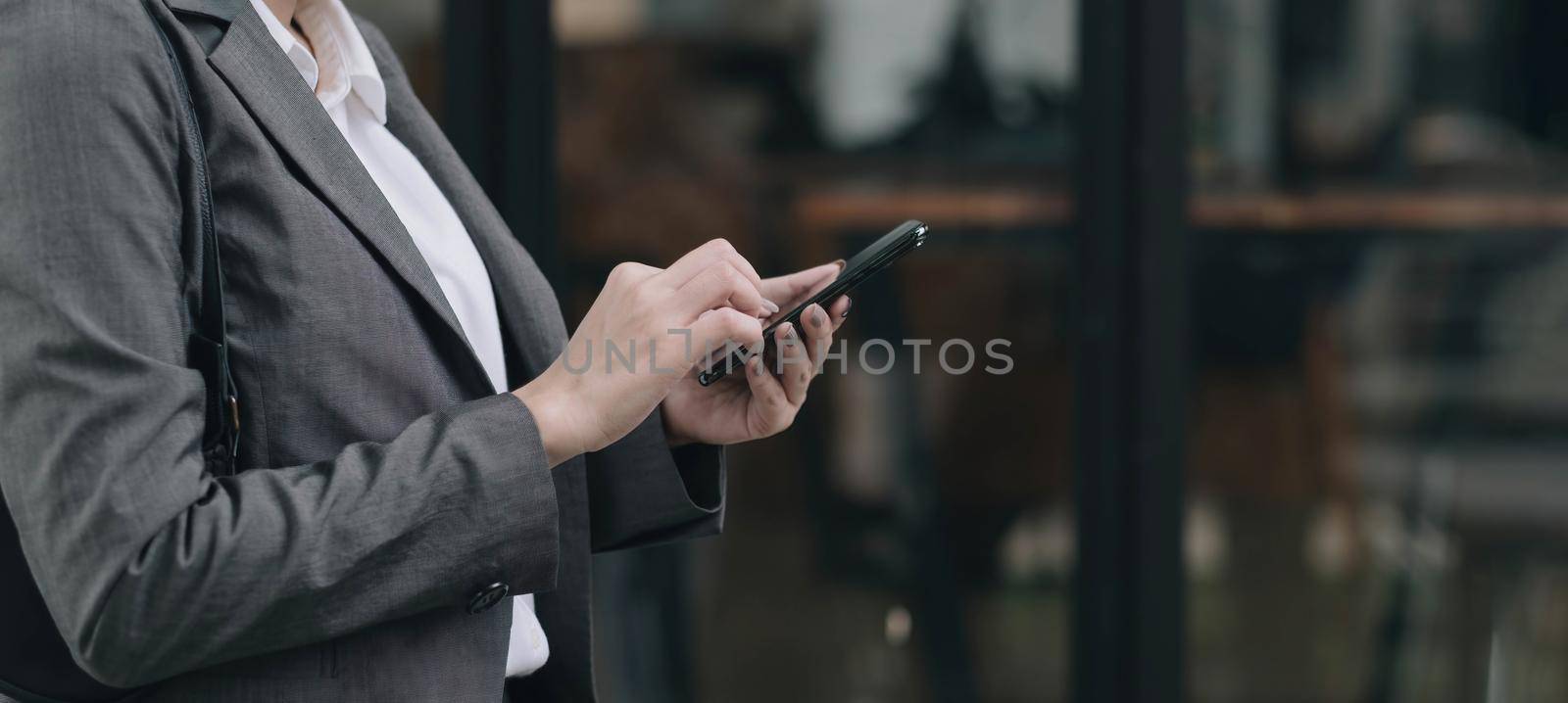 woman using apps on a mobile touchscreen smartphone. Concept for using technology, shopping online, mobile apps, texting, addiction, swipe up, swipe down. by wichayada