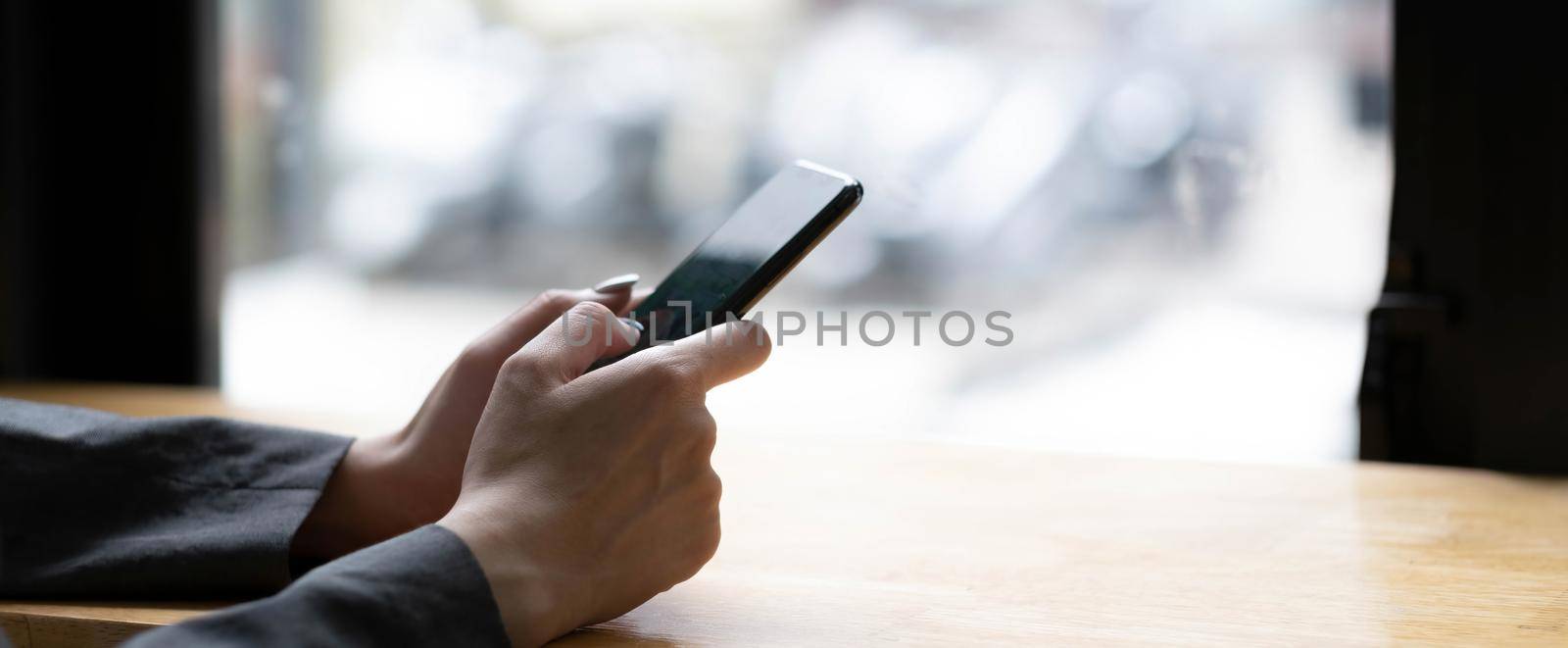 woman using apps on a mobile touchscreen smartphone. Concept for using technology, shopping online, mobile apps, texting, addiction, swipe up, swipe down. by wichayada