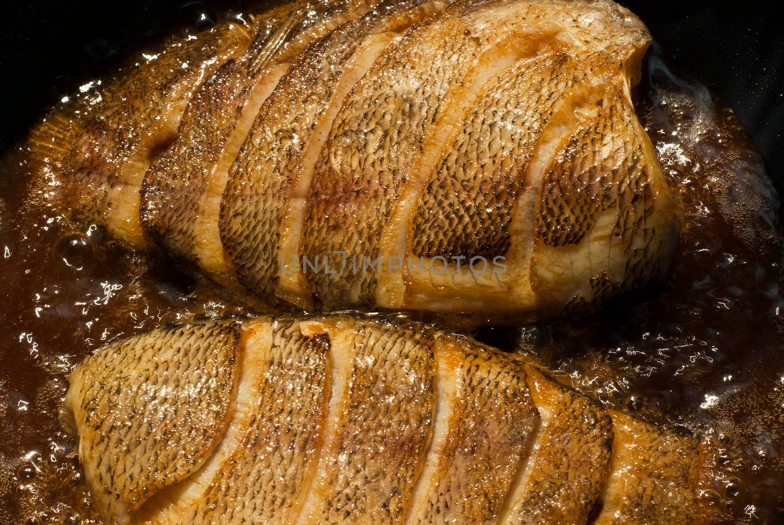 Sun-dried snakeskin gourami, fried in a pan