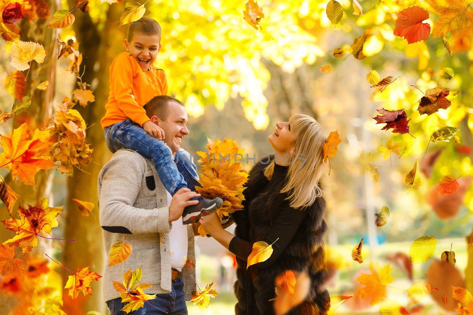 Family playing in autumn park having fun by Andelov13