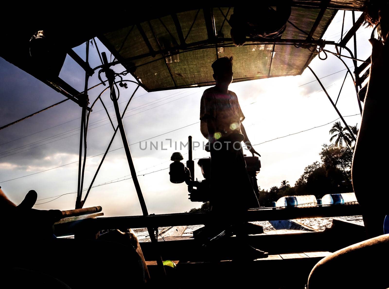 Silhouette of a passenger boat driver in the daytime backlit