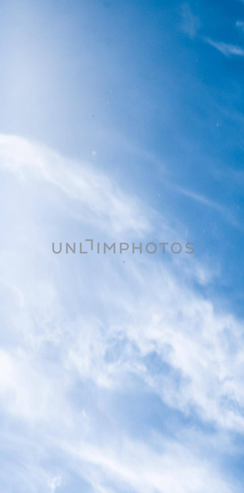 Nature backdrop, solar energy and spiritual concept - Blue sky background, white clouds and bright sunlight