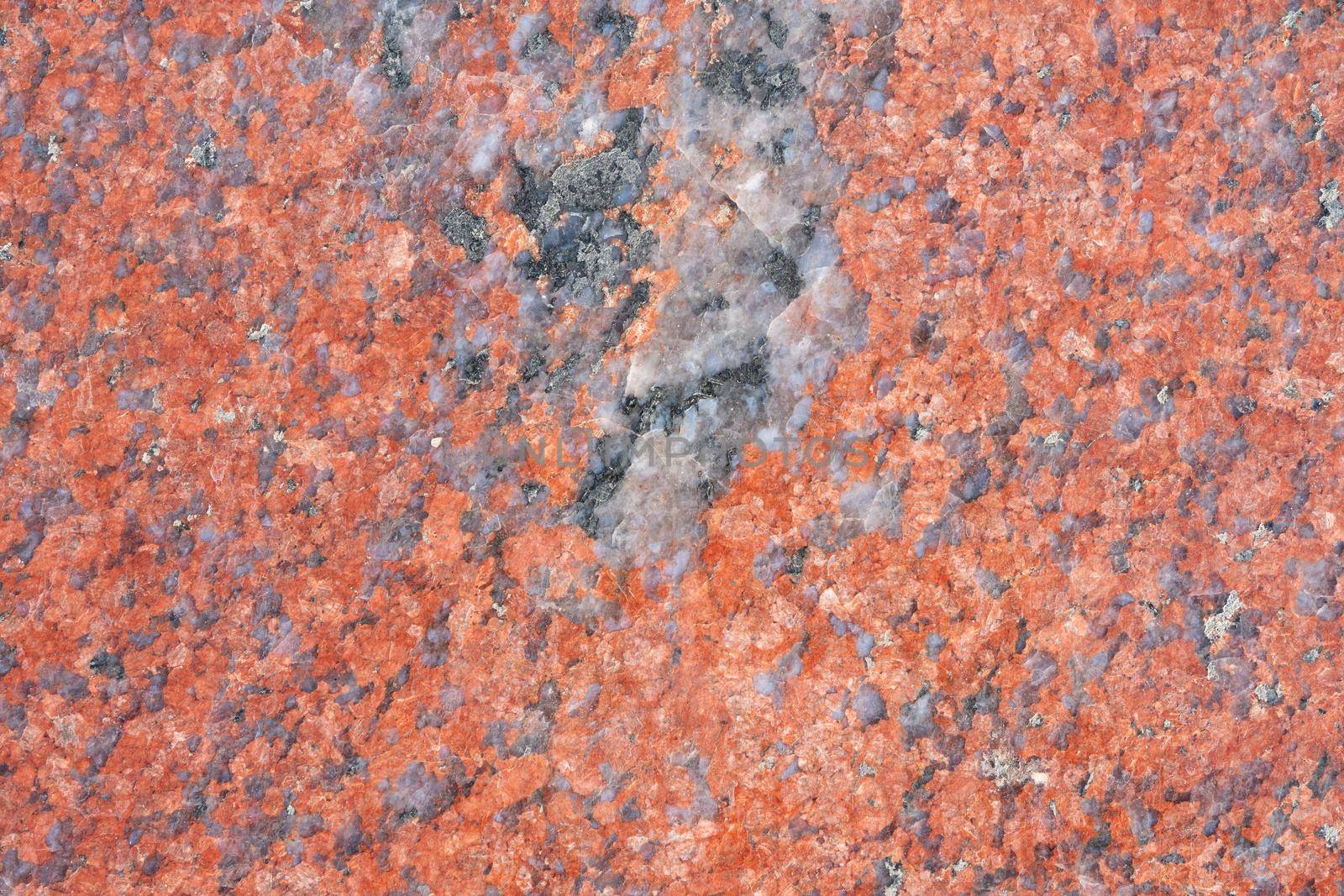 Background texture of polished red granite, close-up.. Abstract granite background for design