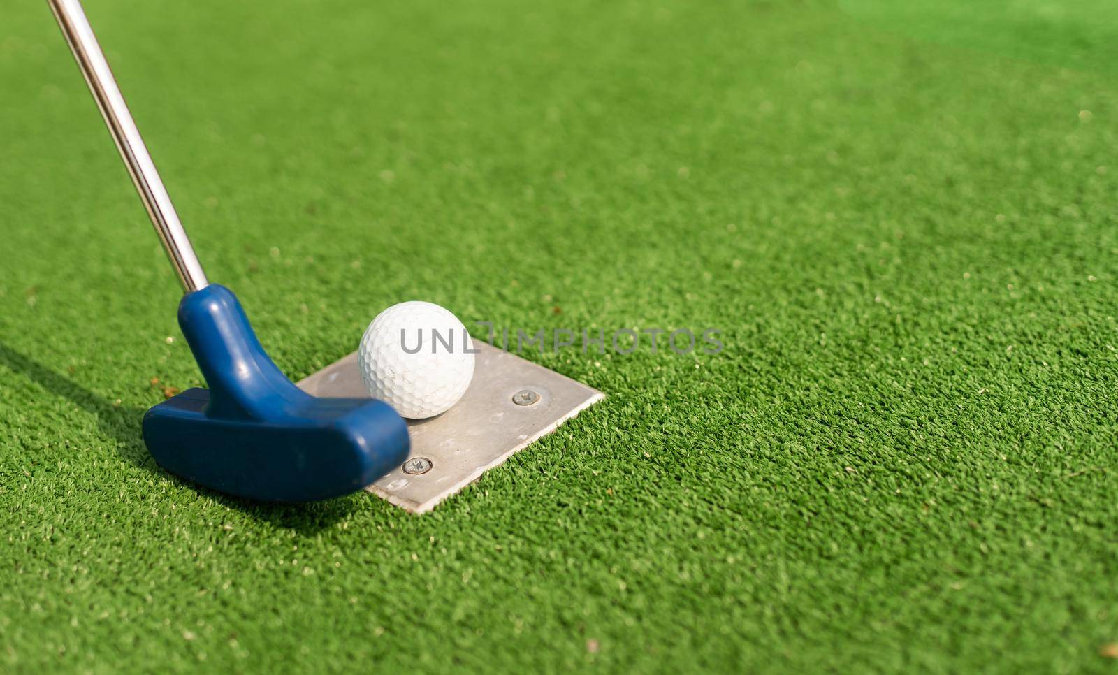 A golf club and a ball during a mini golf game by Andelov13