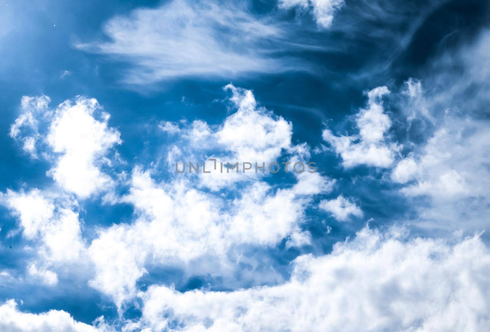 Nature backdrop, solar energy and spiritual concept - Blue sky background, white clouds and bright sunlight