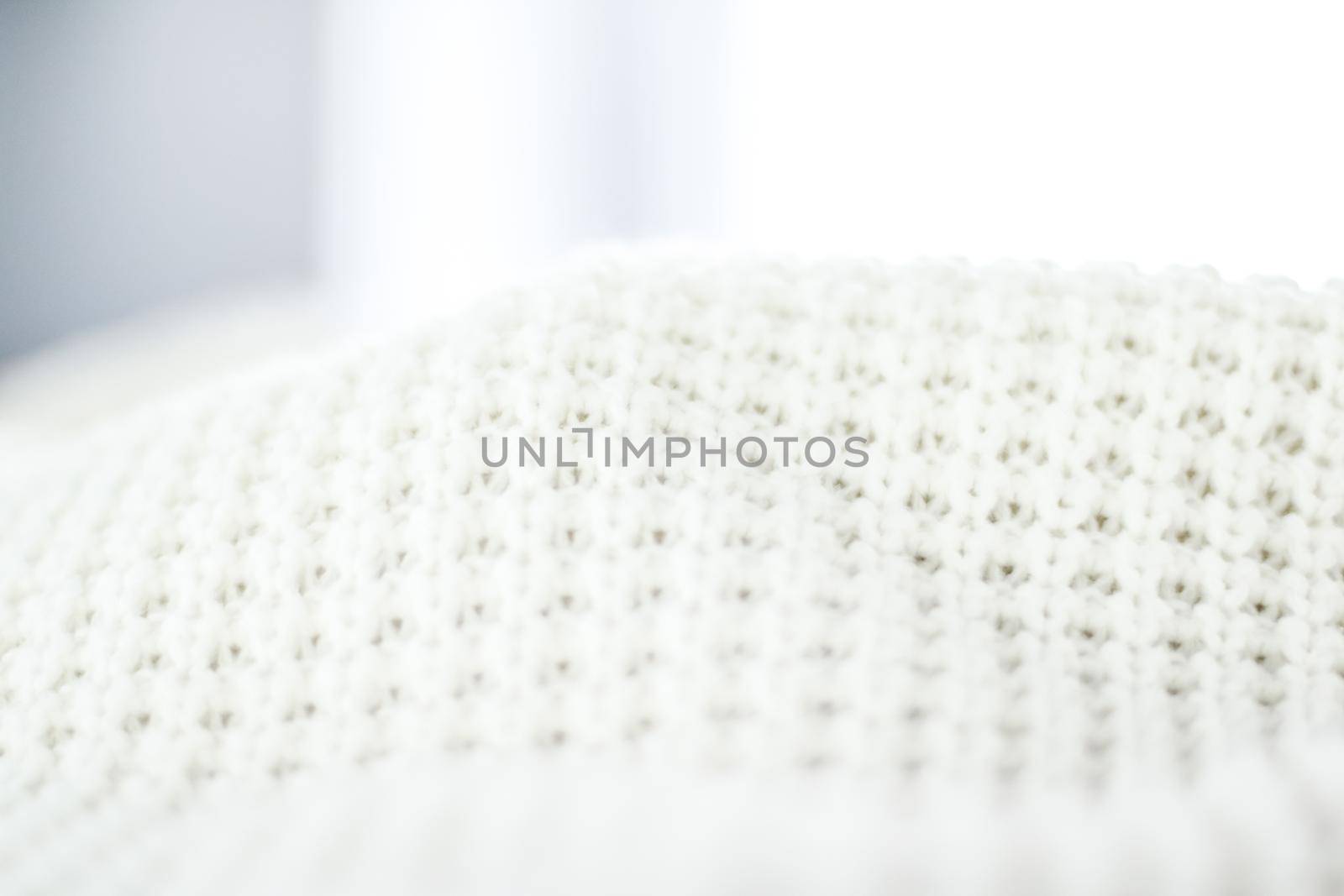 Knitwear, fabric textures and handmade items concept - Warm knitted clothes, soft and white