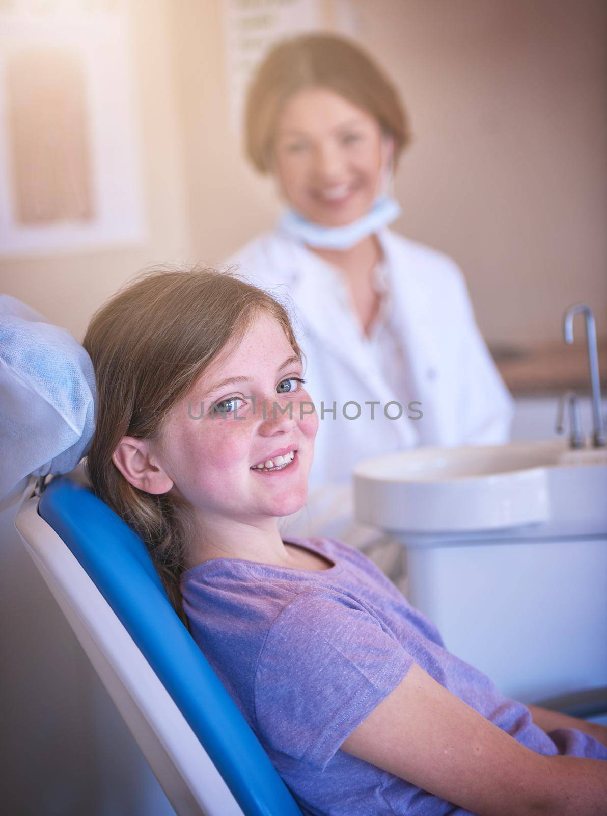 Dentist visits are actually quite fun. a little girl at the dentist for a checkup