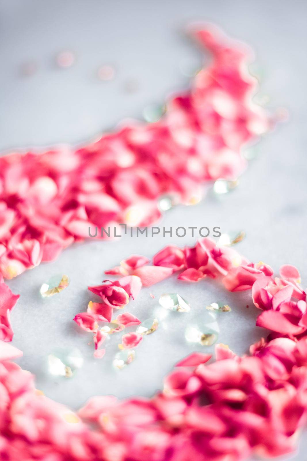 Rose petals on marble stone, floral background by Anneleven