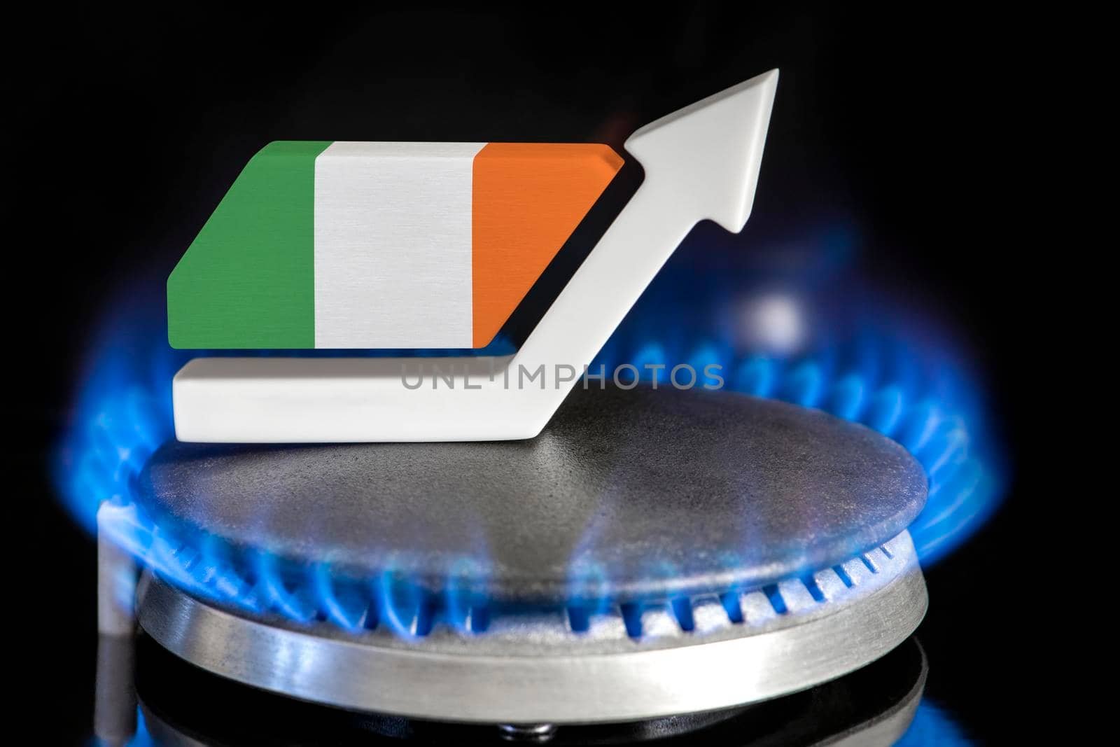 Gas price. Rise in gas prices in Ireland. A burner with a flame and an arrow up, painted in the colors of the Ireland flag. The concept of rising gas or energy prices. by SERSOL