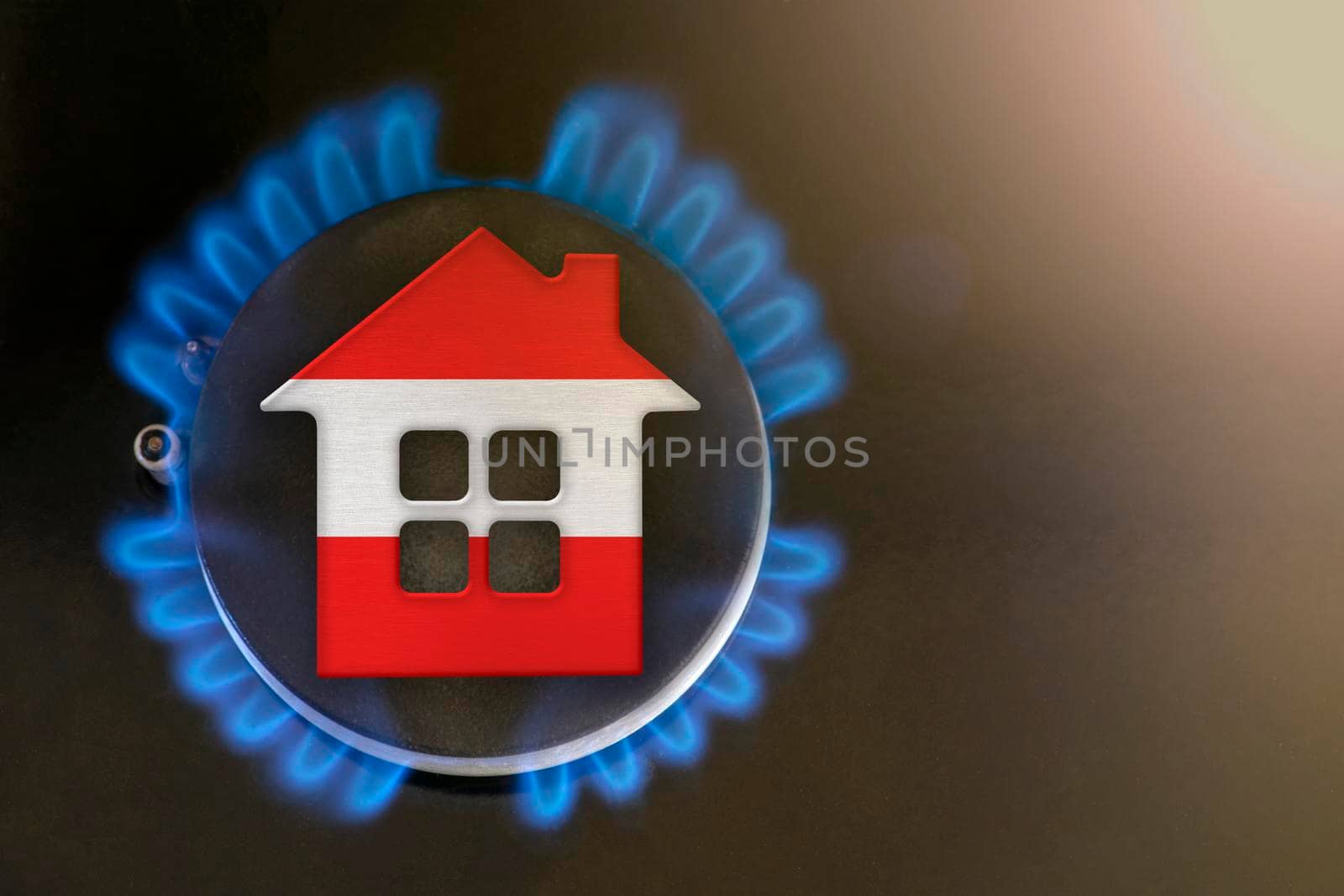 gas crisis. Rising utility costs in Austria. Energy crisis, export-import problems in Austria. The concept, gas burner and house model are colored in the colors of the flag