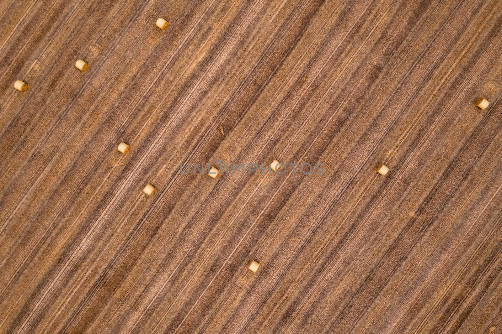 Shot of straw bales in a field after the grain harvest as seen from the air directly from above
