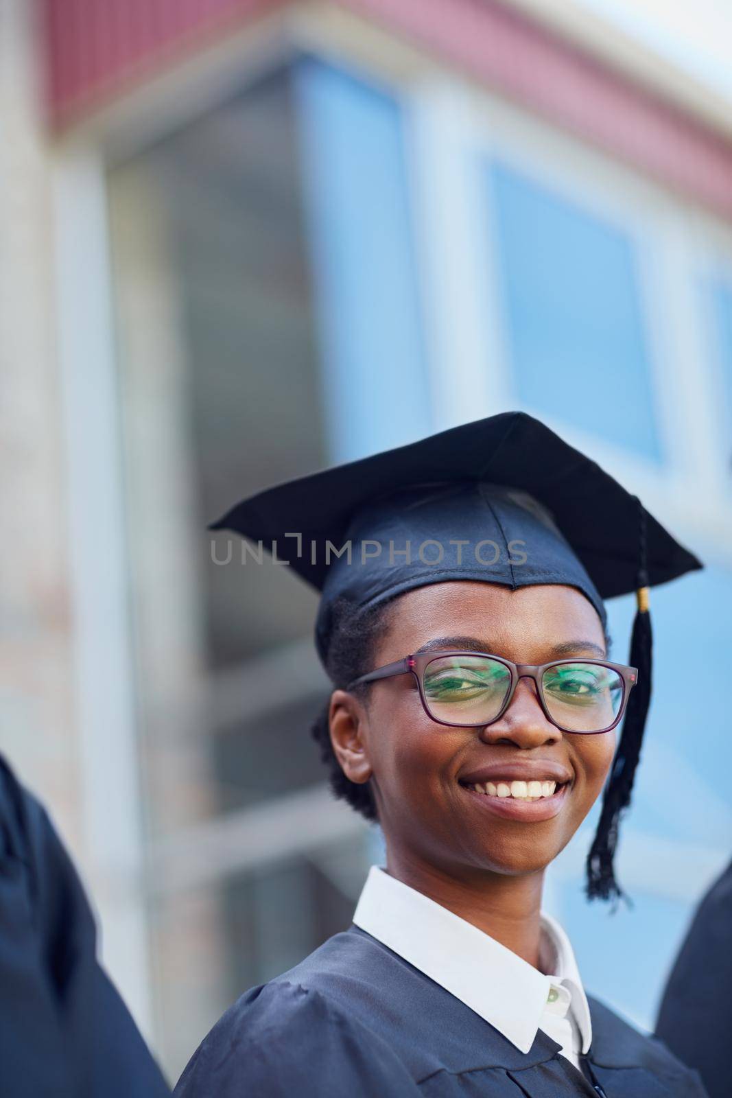 Making my family proud. Portrait of a happy female student standing outside on her graduation day