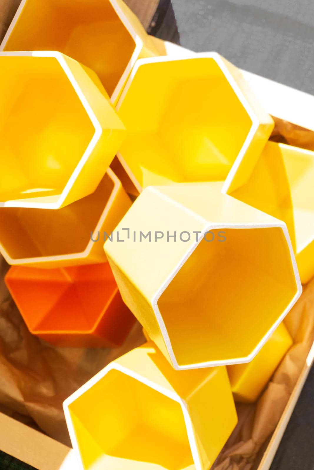 Yellow flower pots handmade in the form of honeycombs close up background