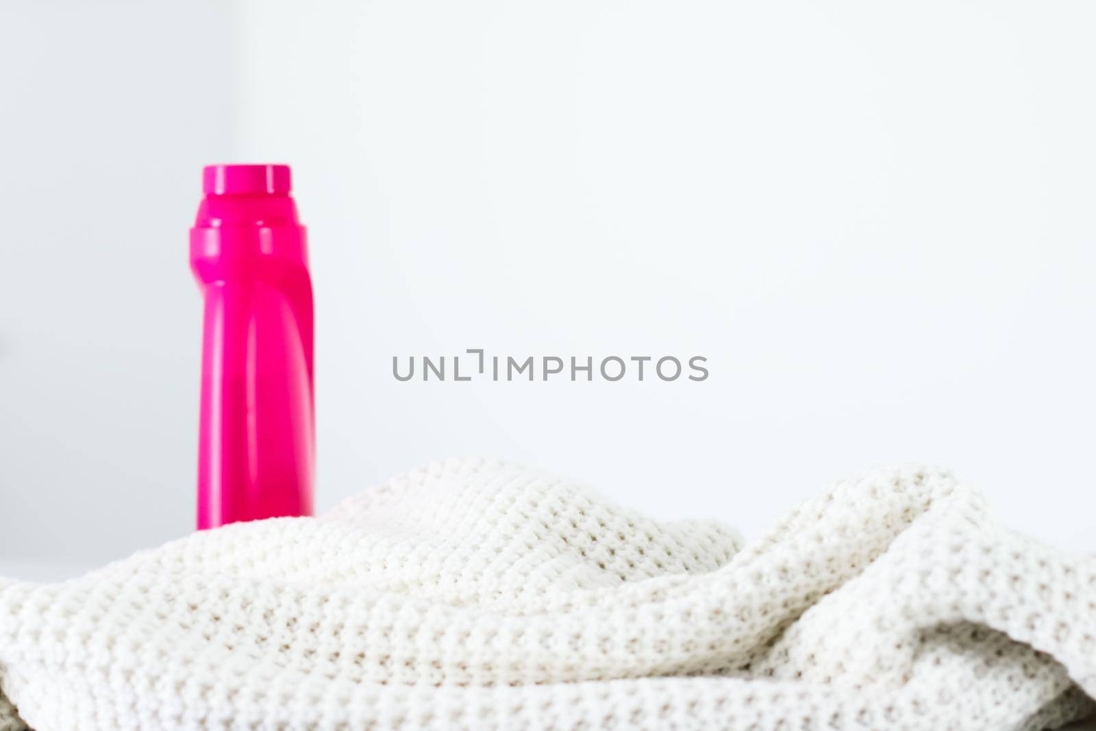 Warm knitted clothes and liquid laundry detergent by Anneleven