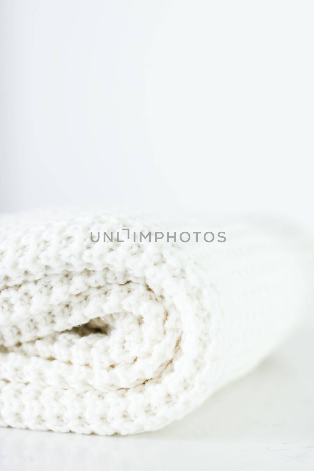 Knitwear, fabric textures and handmade items concept - Warm knitted clothes, soft and white