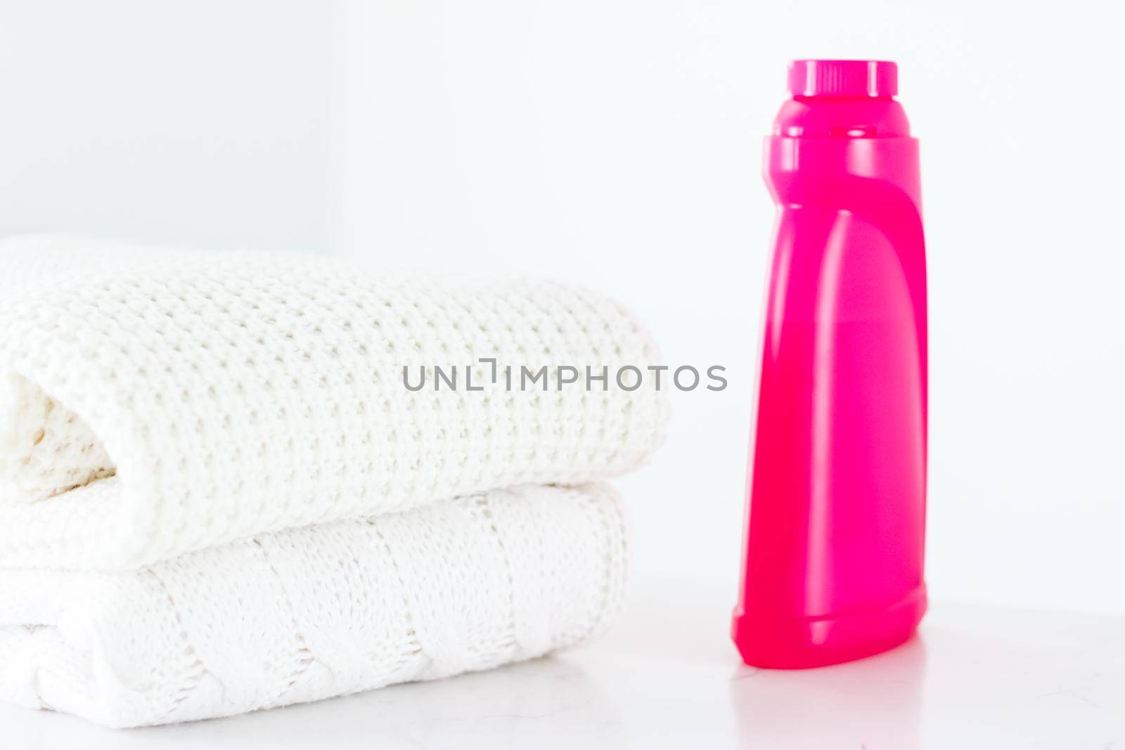 Warm knitted clothes and liquid laundry detergent by Anneleven