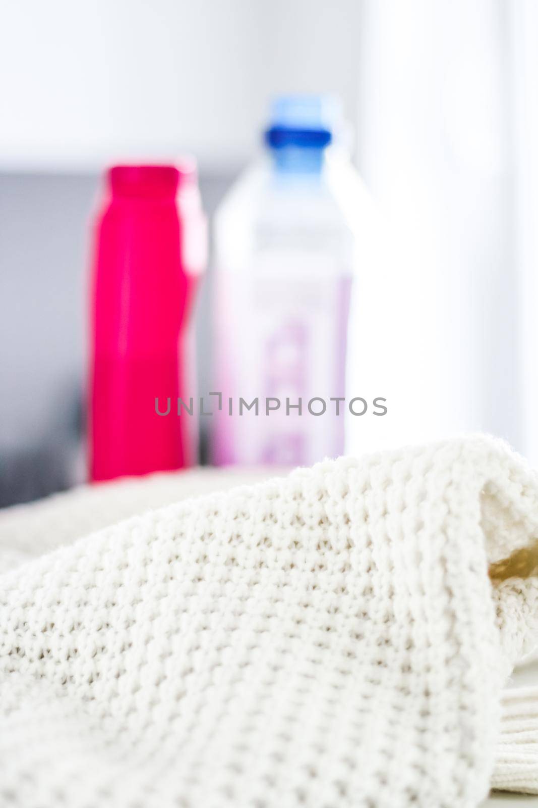 Warm knitted clothes and liquid laundry detergent by Anneleven