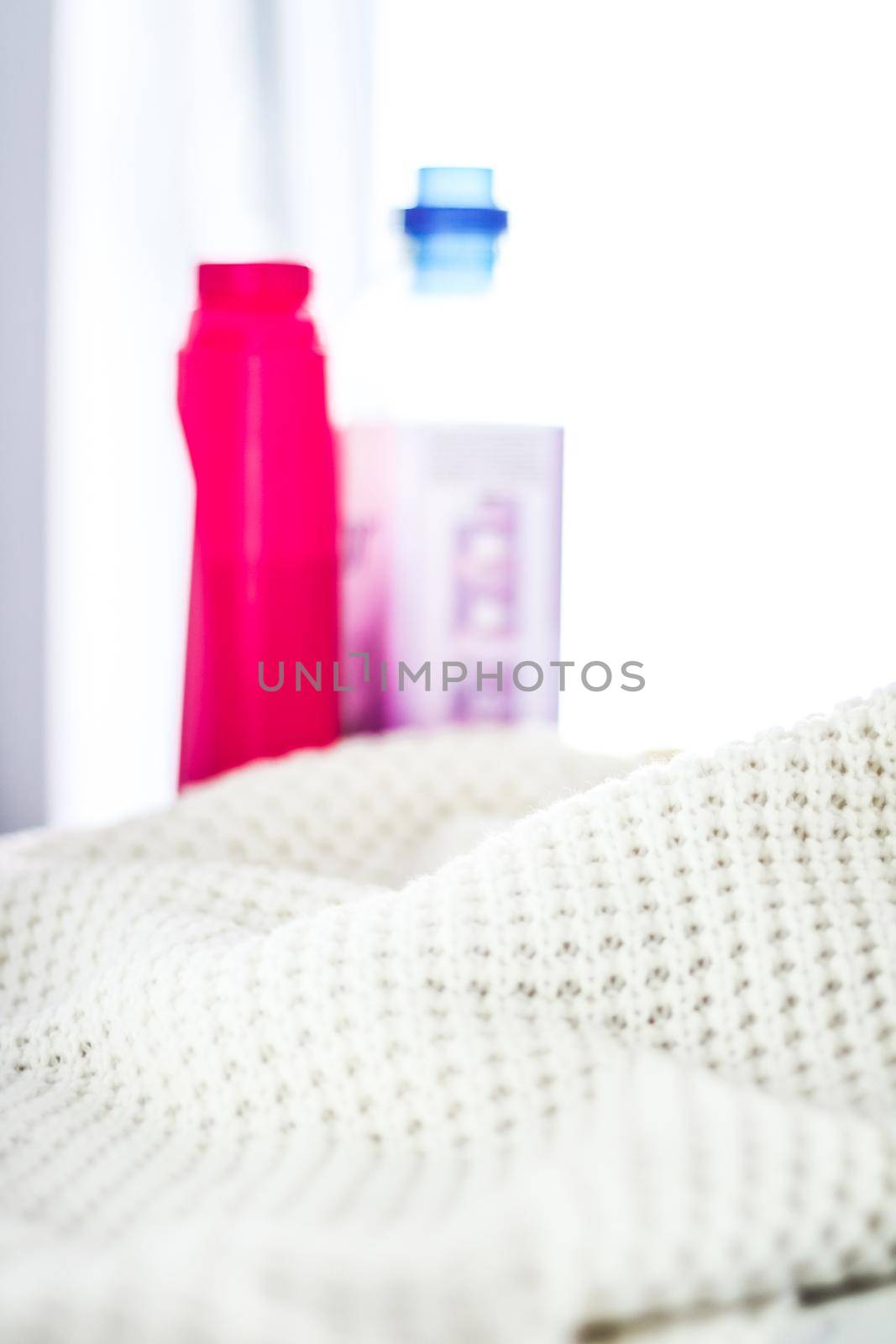 Warm knitted clothes and liquid laundry detergent by Anneleven