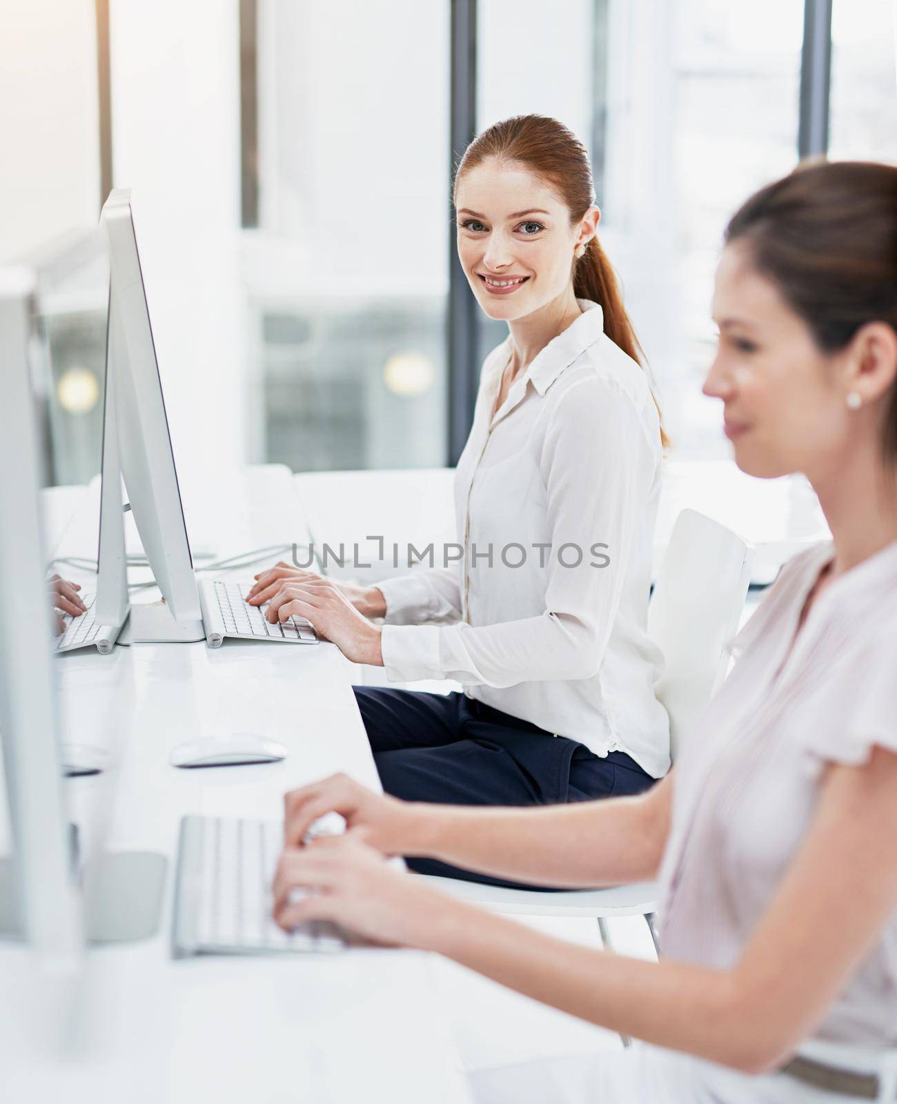 We use technology to maximize our productivity. businesswomen working at their desk