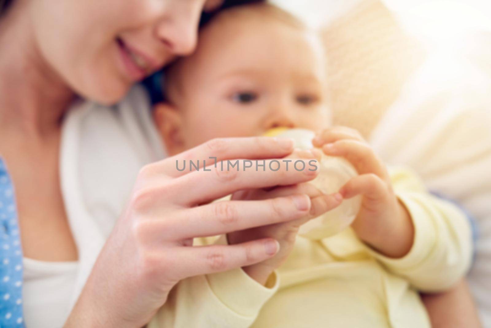 Theres nothing more precious than a mothers touch. a baby drinking his bottle while lying in his mothers arms