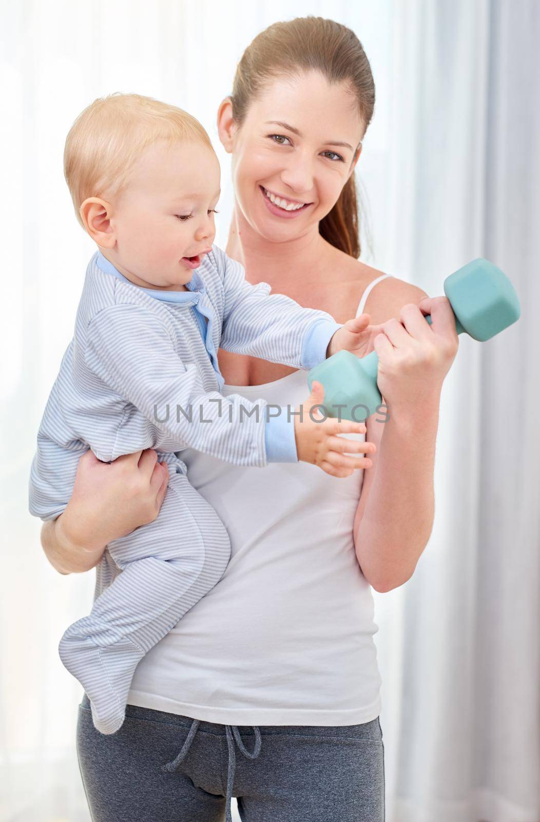 Ill take that for now. a young woman working out while spending time with her baby boy