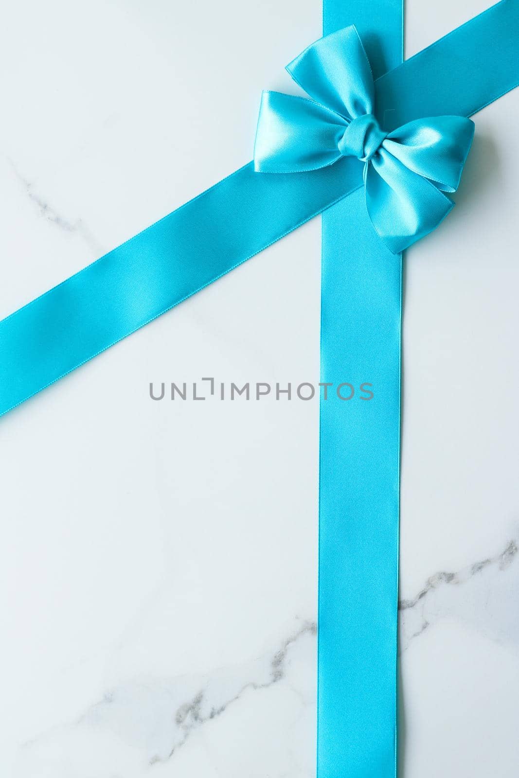 Holiday decor, feminine design and flatlay concept - Blue silk ribbon on marble, top view