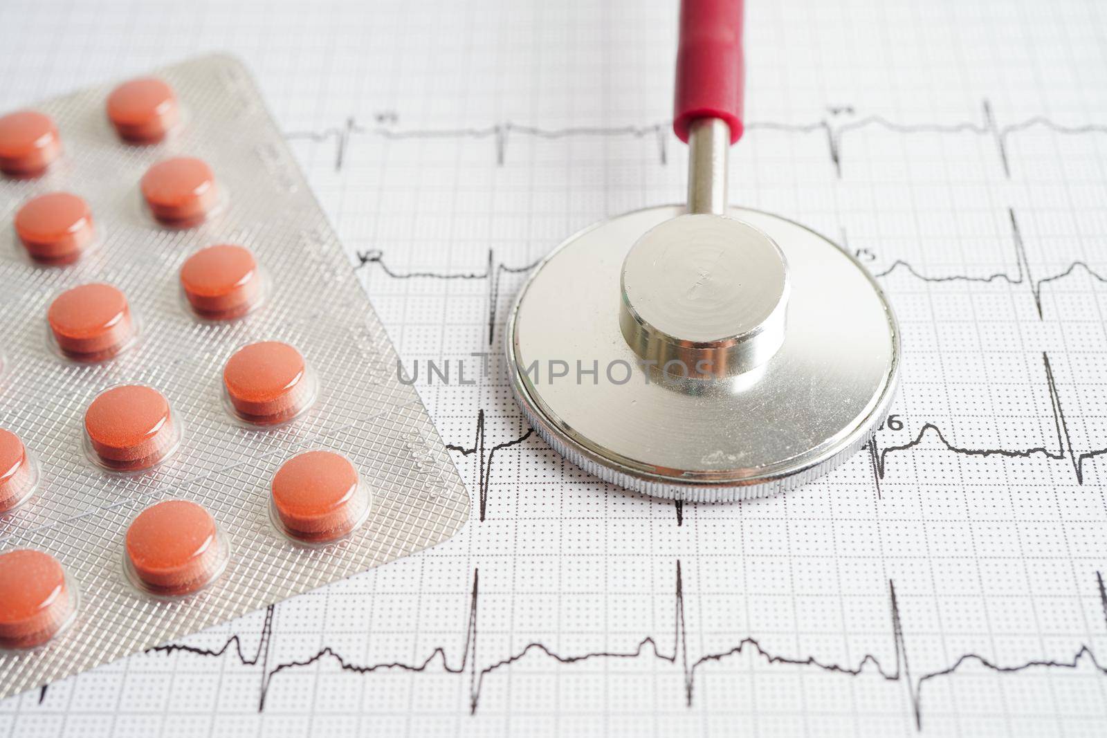 Stethoscope on electrocardiogram (ECG) with drug, heart wave, heart attack, cardiogram report.