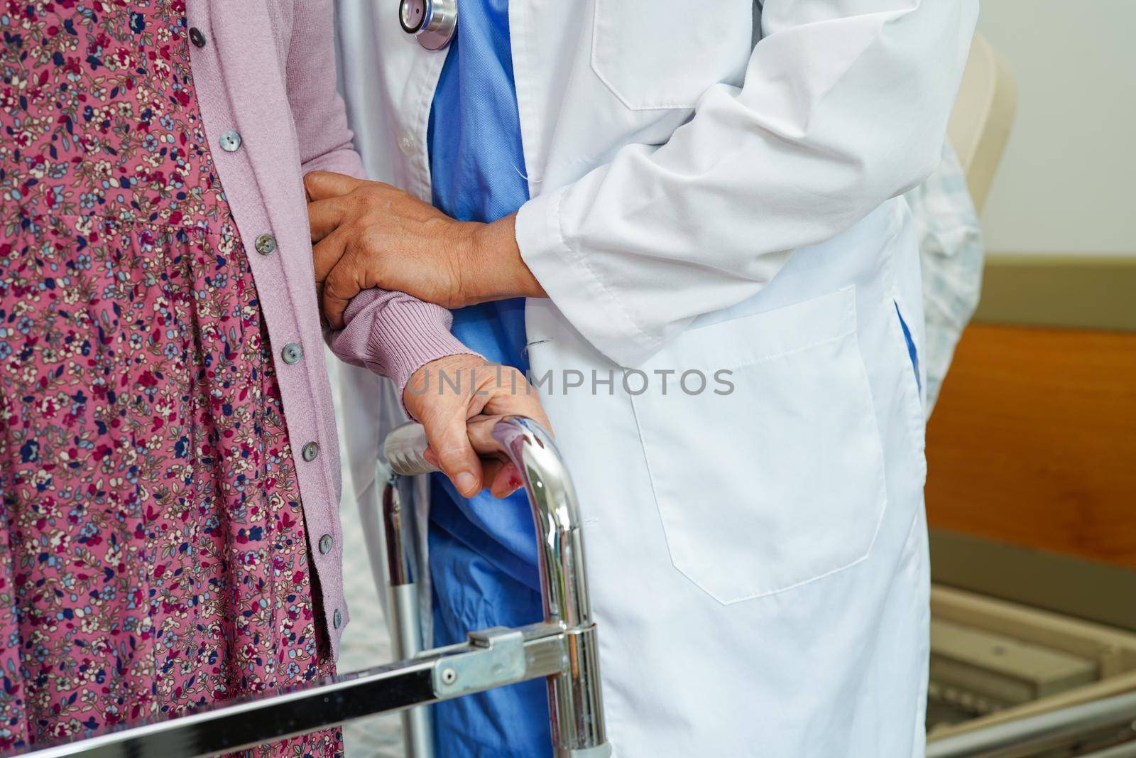 Doctor help Asian elderly woman disability patient in nursing hospital, medical concept.