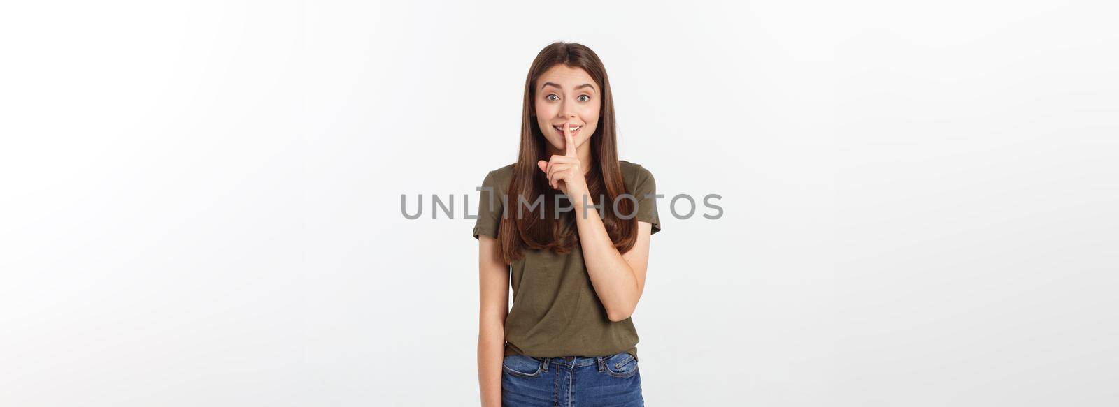 Beautiful woman showing finger over lips isolated on a white background