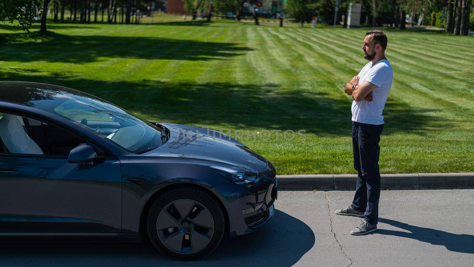 Caucasian man connect charger to electric car