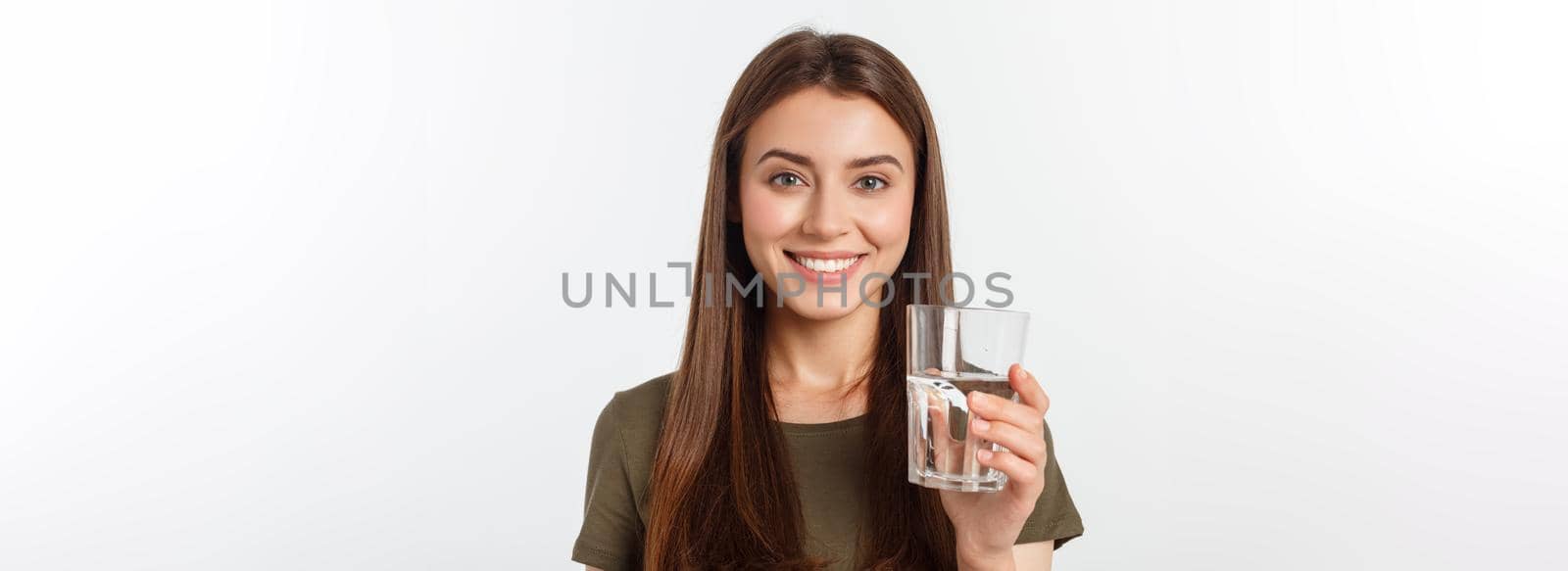 portrait of attractive caucasian smiling woman isolated on white studio shot drinking water