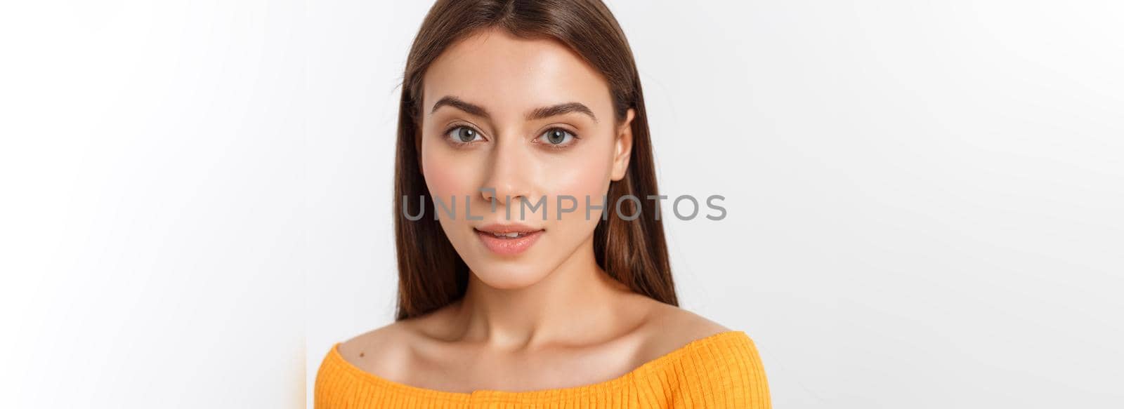 friendly smiling young woman with beatiful face portrait studio shot.