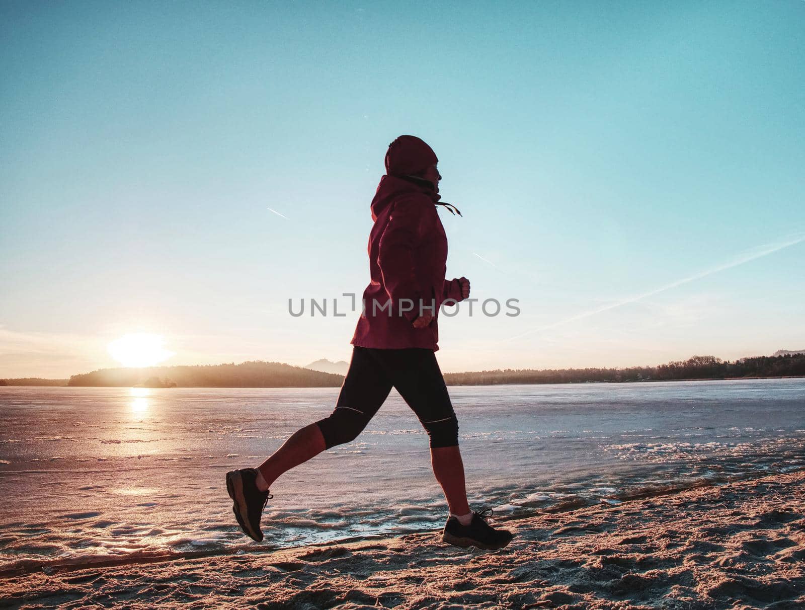 Running sport woman. Female runner jogging at winter bay by rdonar2