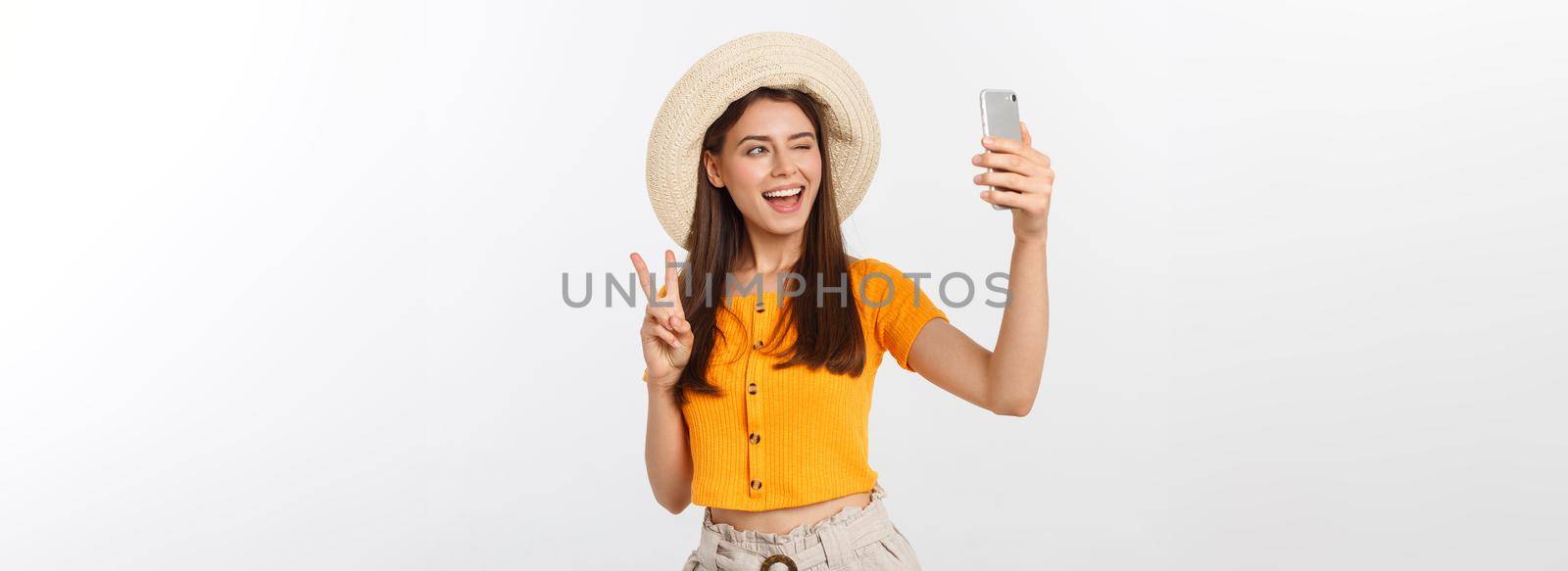 Young Caucasian woman enjoying the selfie with herself isolated on white background summer travel concept