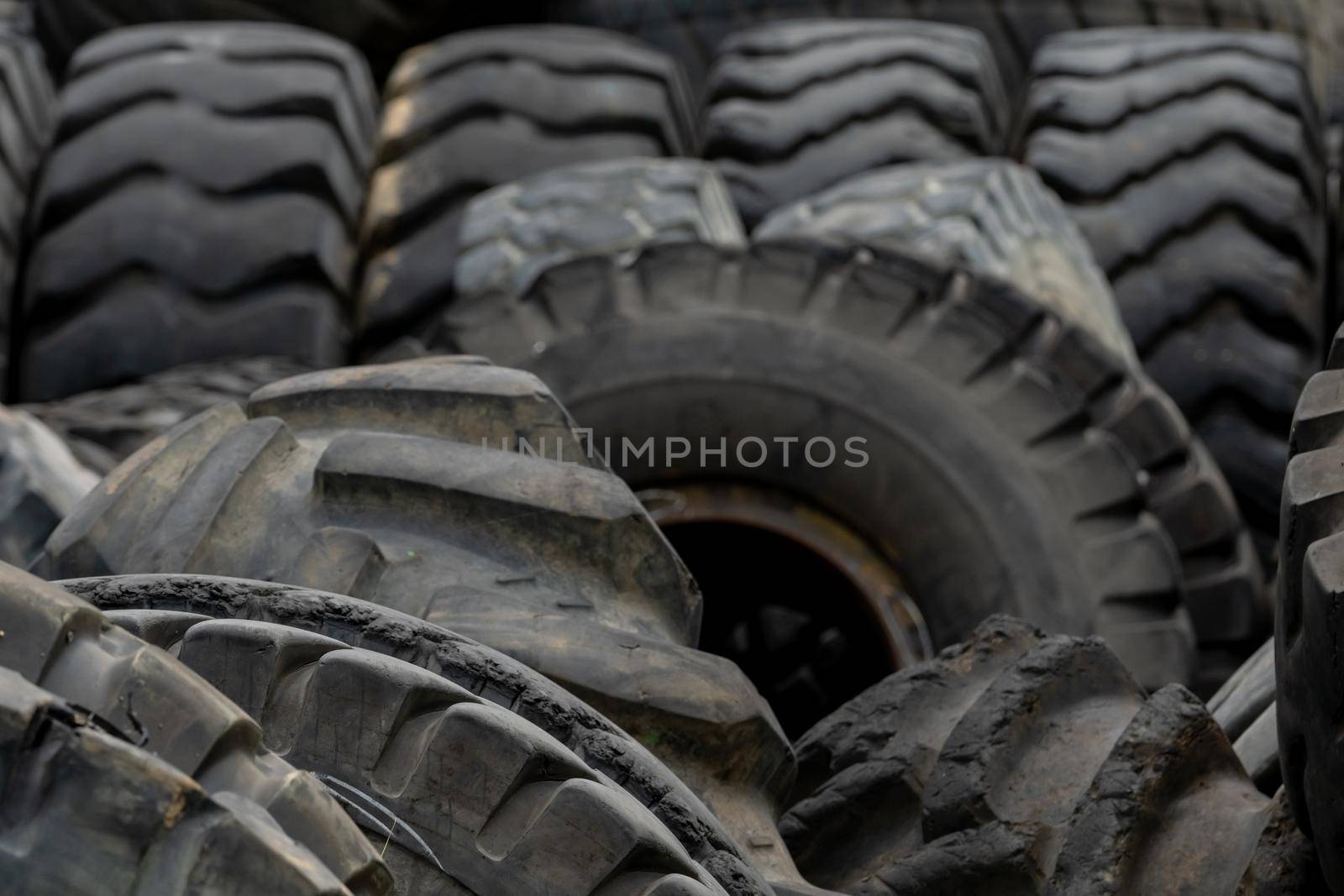 Closeup used truck tires. Old tyres waste for recycle or for landfill. Black rubber tire of truck. Pile of used tires at recycling yard. Material for landfill. Recycled tires. disposal waste tires. by Fahroni