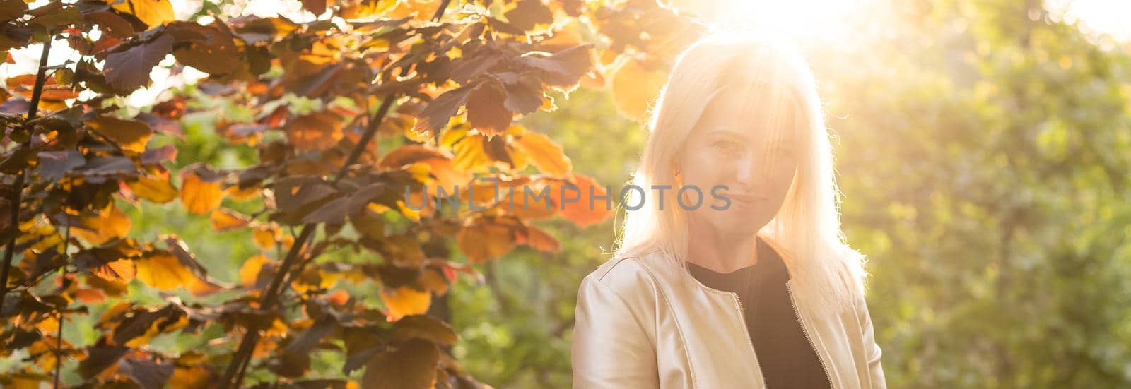 Young attractive cheerful woman walking in city