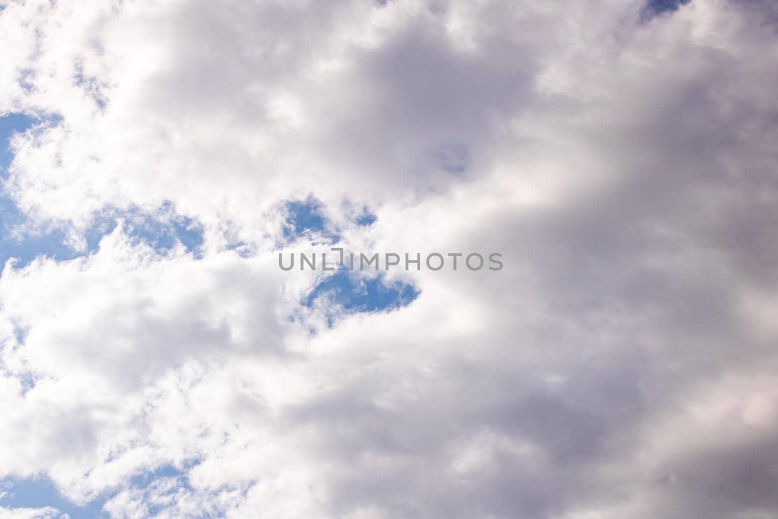 Clouds in the bright blue sky, background or texture