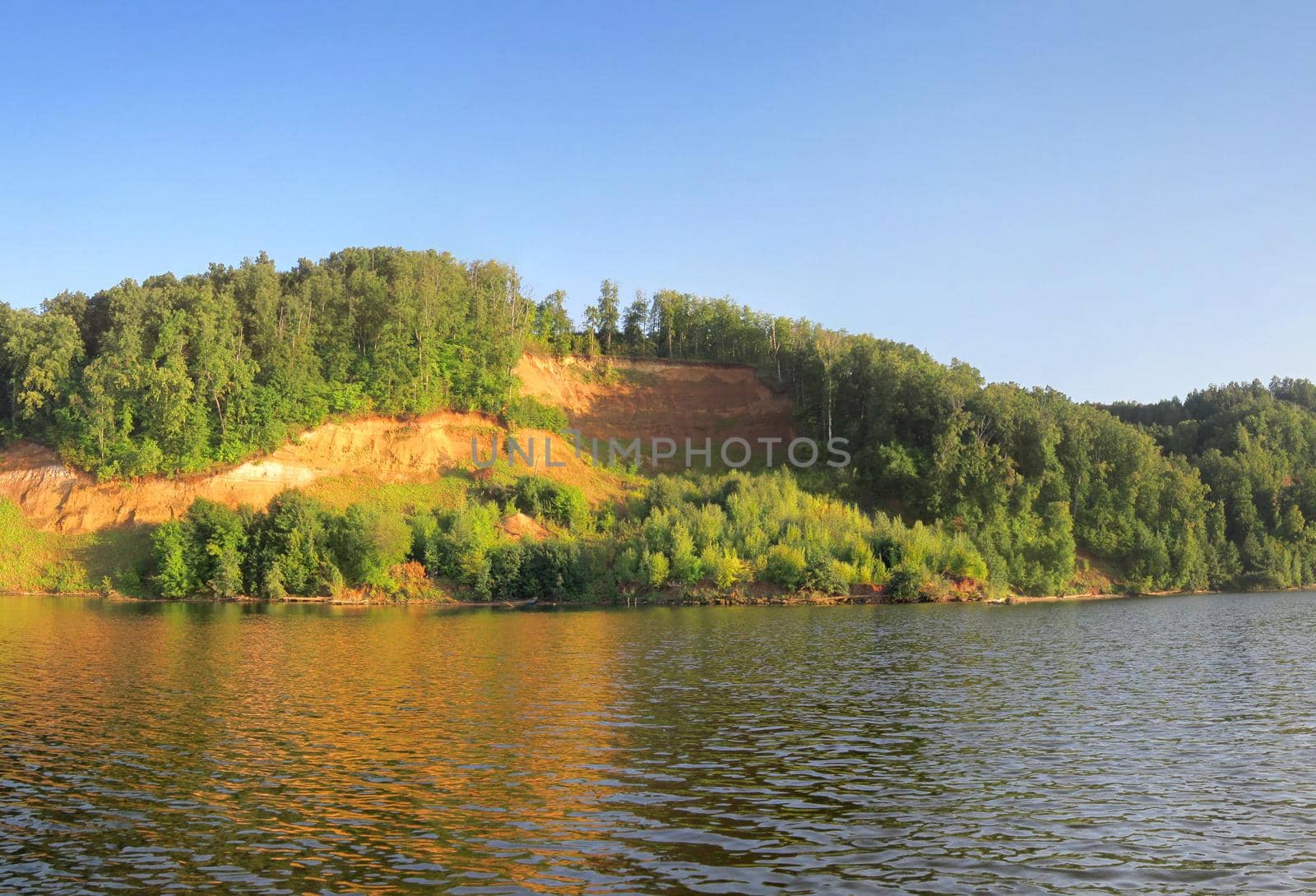 Russian River with cliff coast under clear blue sky. Scenic Colorful Nature Landscape of Russian Summer.