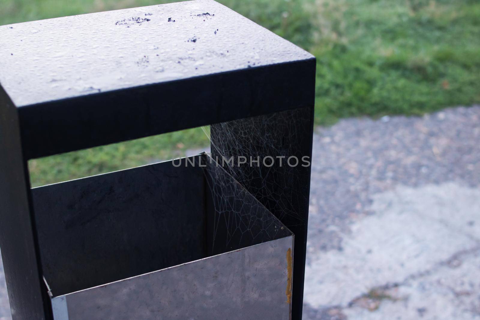 Street trash can in the park closeup in autumn